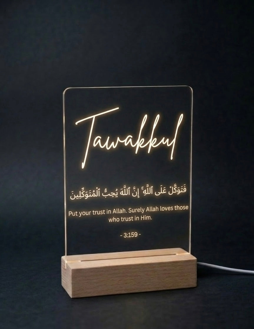 LED sign with 'Tawakkul' and Arabic text on a dark background