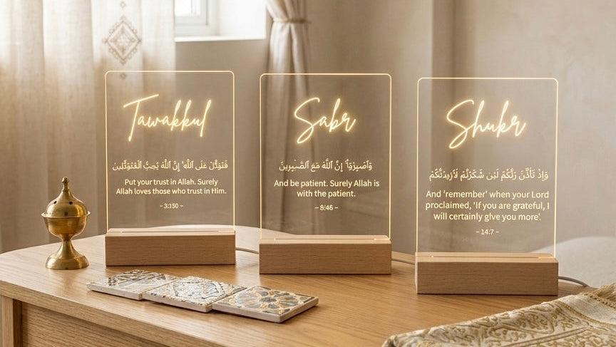 Decorative items on a wooden table with the words tawakkul sabr and shukr in arabic and english 