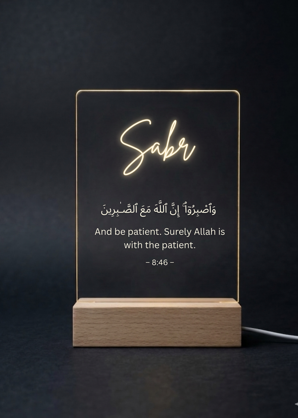 Decorative LED sign with 'Saber' and Arabic text on a black background