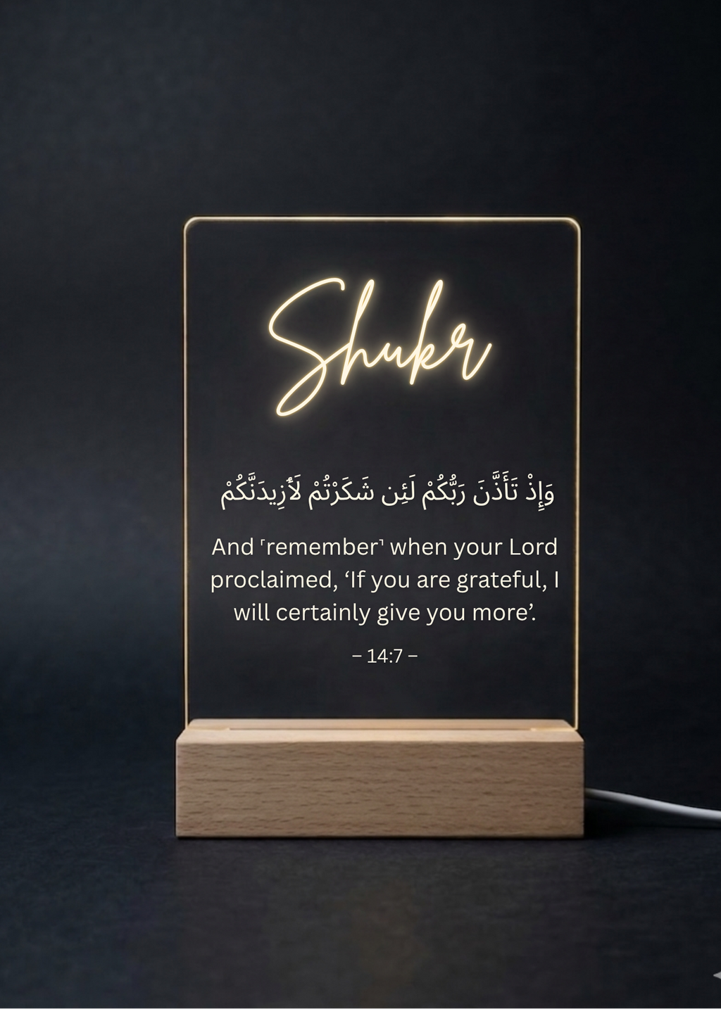 Decorative LED sign with 'Shuker' and Arabic text on a dark background