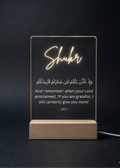 Decorative LED sign with 'Shuker' and Arabic text on a dark background