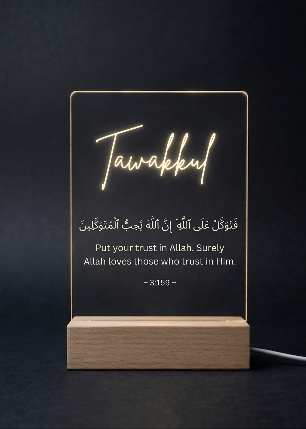 LED sign with 'Tawakkul' and Arabic text on a dark background